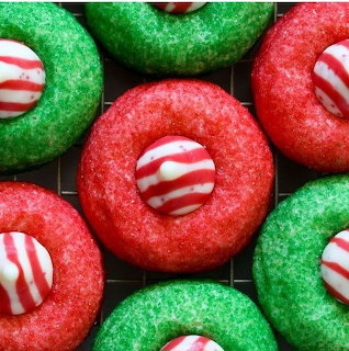 Red and green sugar cookies with striped peppermint candy centers arranged together