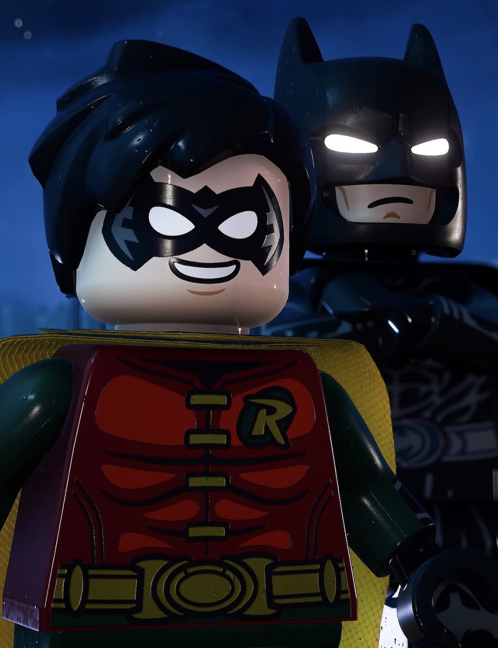 Close-up of Lego Robin with Lego Batman behind on a dark blue background