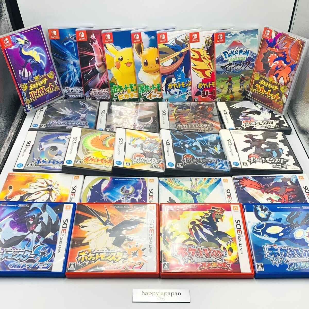 Collection of Pokemon game boxes and cases displayed on a table