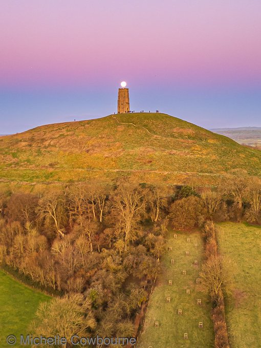 Glastonbury Tor with St Michael's Tower on a green hill in Somerset