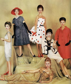 Six women modeling1960s haute couture dresses in various styles posed together in a studio
