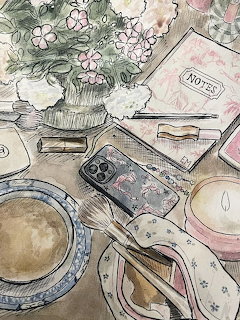 Watercolor painting of a tabletop with flowers in a vase, notebook, phone, teacup, and plate