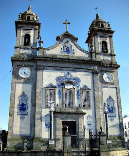 Front facade of Igreja de Valongo church with blue azulejo tiles and twin clock towers, Portugal