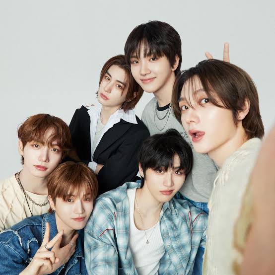 Six BOYNEXTDOOR members posing together in a studio portrait
