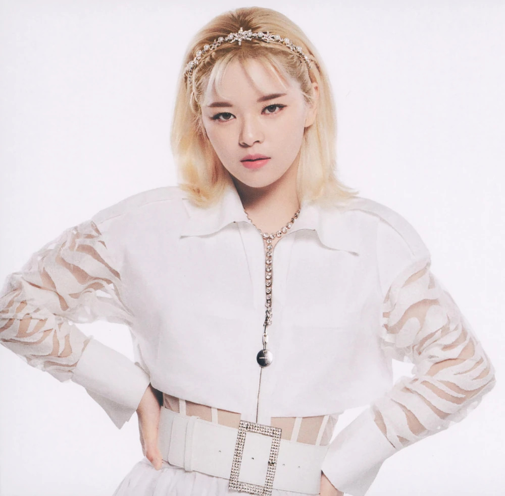 Studio portrait of Jeongyeon wearing a white blouse and headband against a light background