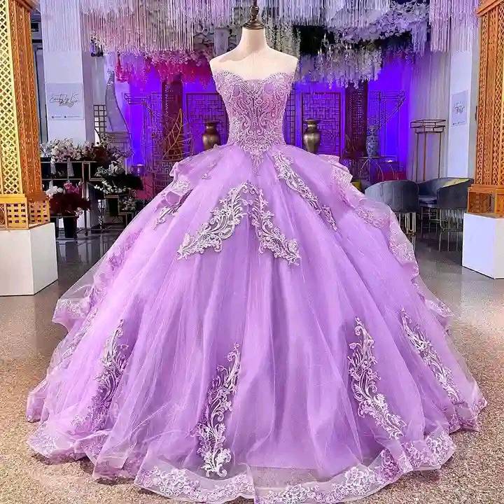 Purple quinceanera ball gown with silver beading on display in formal event space