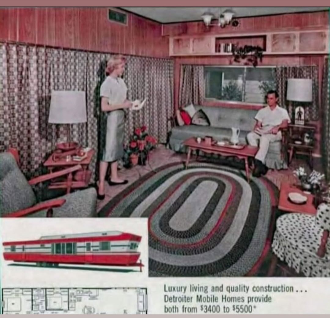 Vintage living room with two people, mid-century furniture, patterned curtains, and an oval rug