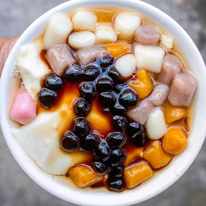 Bowl of Taiwanese dessert with boba pearls, taro balls, and jellies in syrup