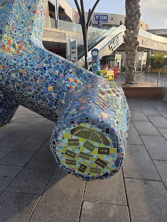 Close-up of a colorful mosaic sculpture in an outdoor plaza