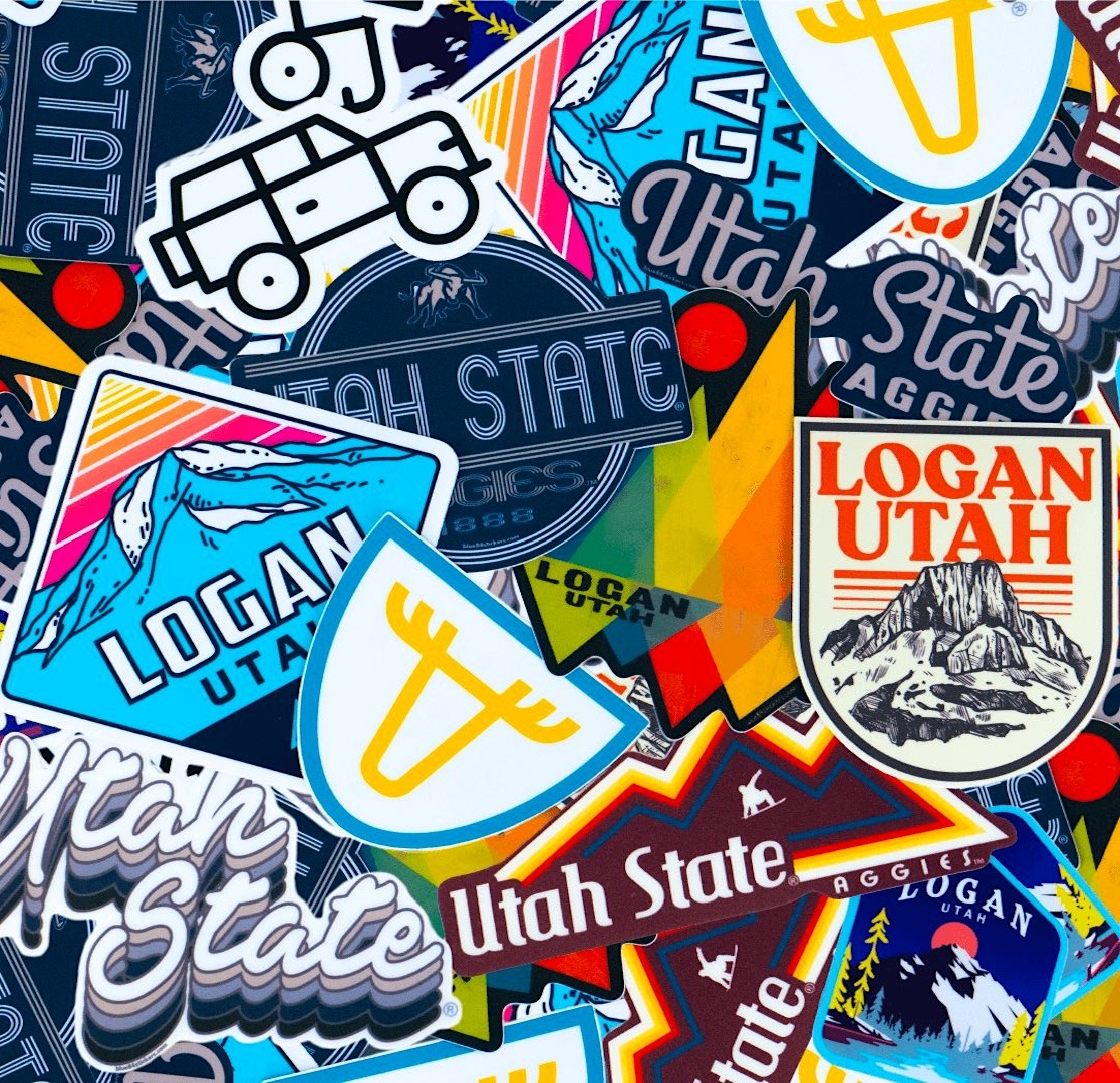 Dense collage of colorful Utah state stickers and decals overlapping in various designs