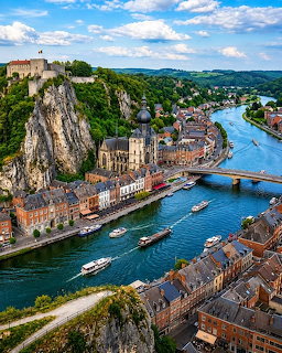Aerial view of Dinant Belgium with river, church, citadel on cliff, and colorful buildings