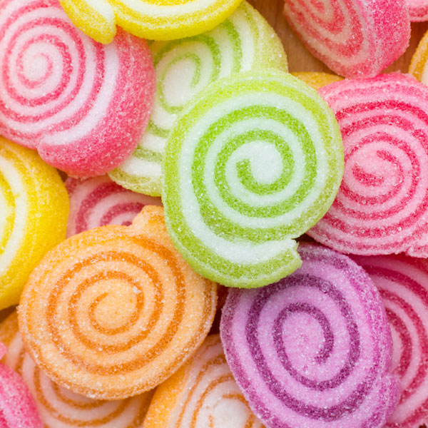 Colorful sugar-coated spiral candy wheels in various bright colors