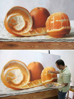 Artist painting a hyperealistic still life of peled oranges on a large canvas