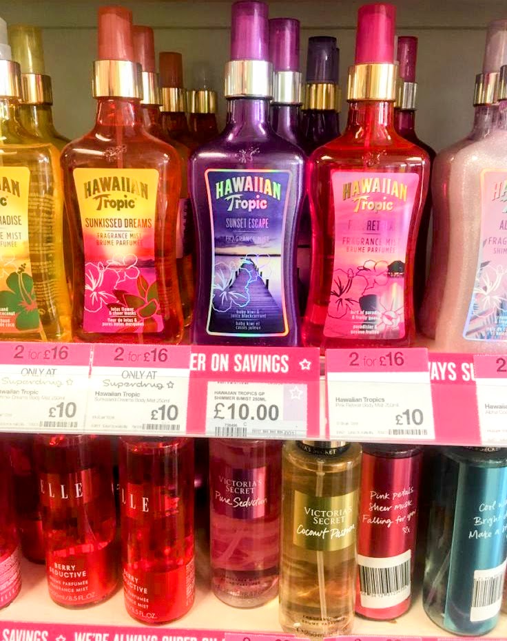Hawaiian Tropic tanning and body spray bottles on a retail shelf