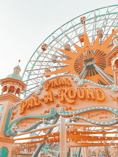 Vintage fairground with decorated carousel and Ferris wheel in orange and teal colors