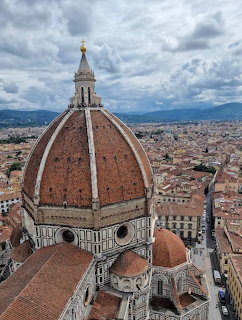 Aerial view of Florence Cathedral dome above the city with cloudy sky