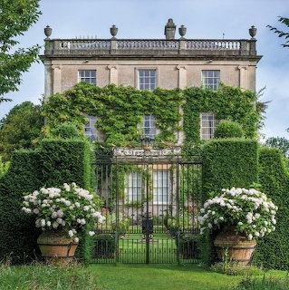 Flower-lined garden path with hedges and trees at Highgrove Gardens, Gloucestershire