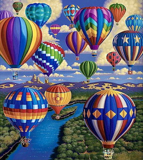 Colorful hot air balloons with geometric patterns floating over river and green landscape under cloudy sky