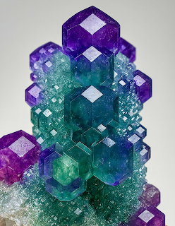 Purple and teal fluorite crystal cluster with geometric cubic formations