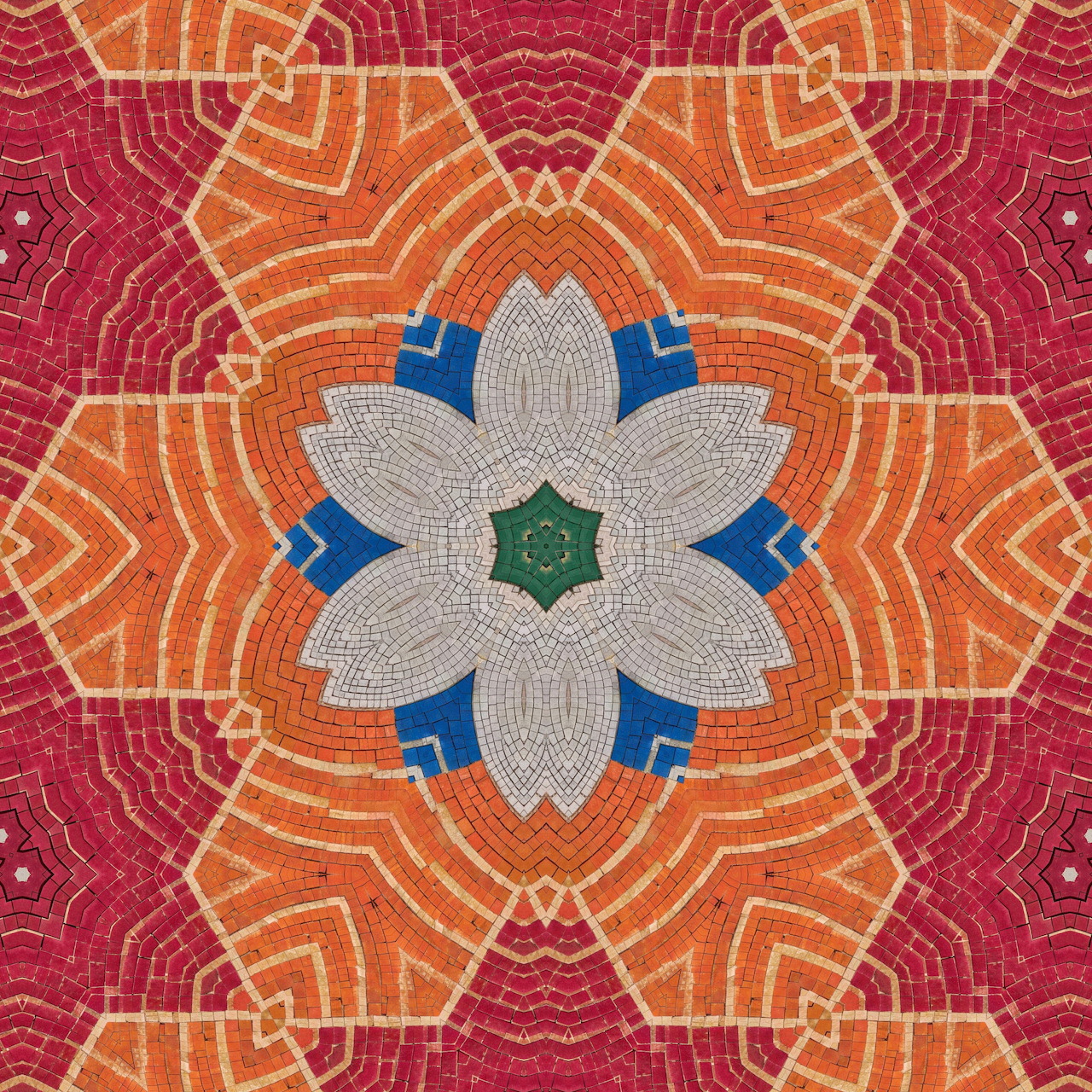 Symmetrical mandala with white flower center, blue petals, orange and magenta radiating geometric mosaic pattern