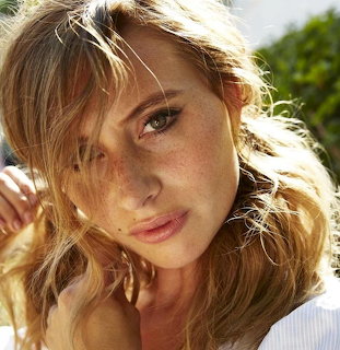 Close-up portrait of Aly Michalka with blonde hair in warm outdoor light