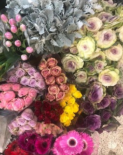 Colorful assorted flower bouquets arranged at market stall, viewed from above