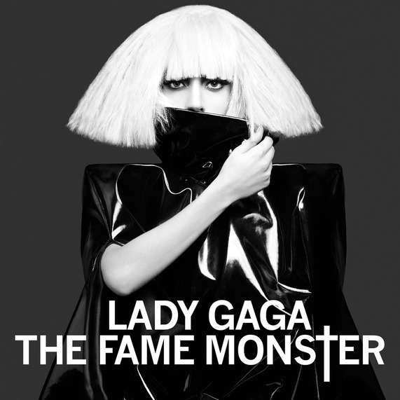 Lady Gaga album cover with blonde bob wig and black outfit on dark background