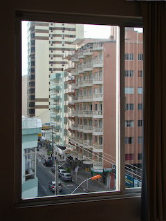 Urban street view with apartment buildings seen through an indoor window frame
