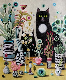 Black cat with white chest among decorative plants in geometric pots on yellow table