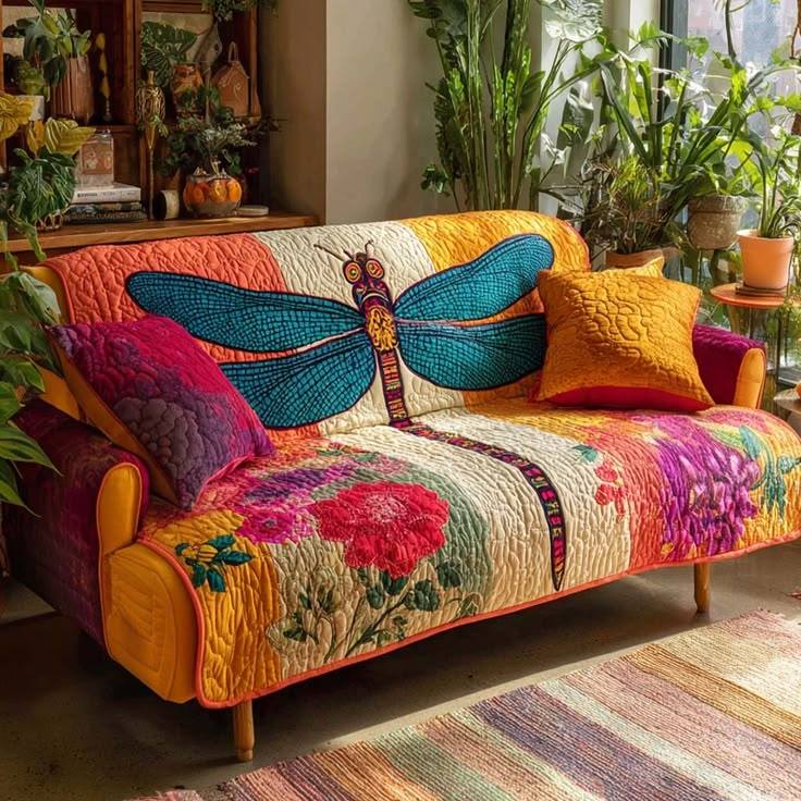 Colorful patchwork sofa with butterfly cushion in sunny bohemian interior with plants