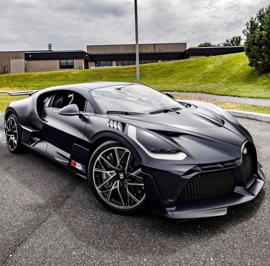 Gray Bugatti Divo supercar parked on road with building behind