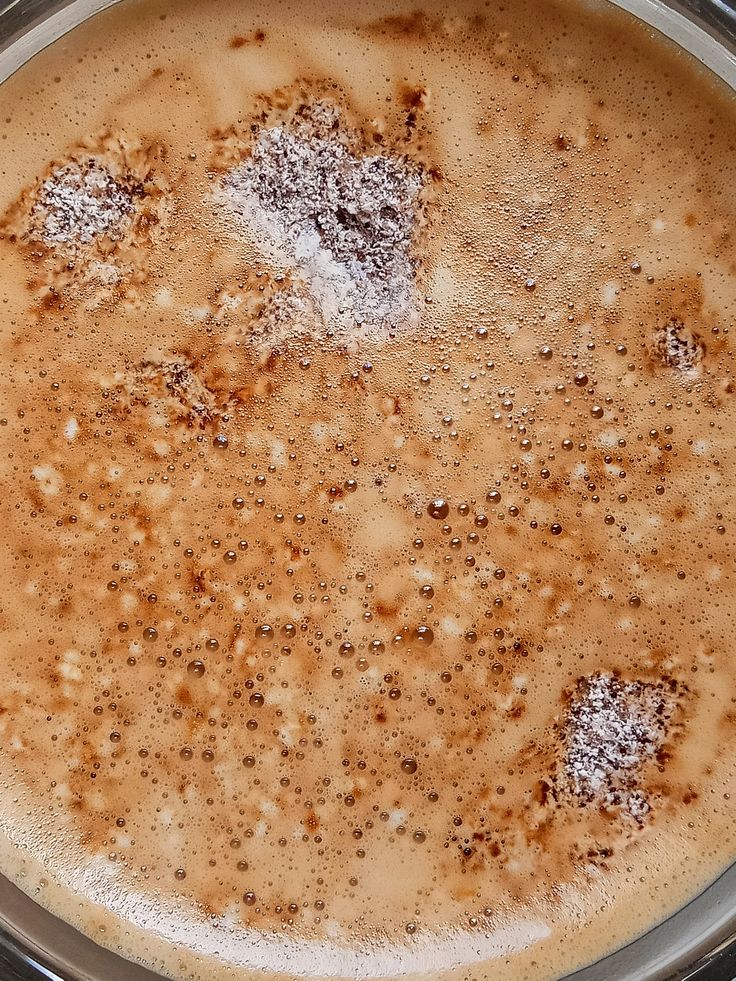 Overhead view of cappuccino with foam and cocoa powder dusting