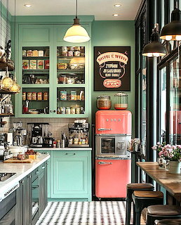 Vintage kitchen with green cabinets, pink refrigerator, and black-white checkered floor