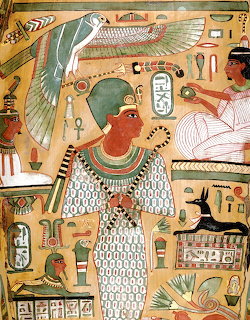 Ancient Egyptian painted figure with ornate collar and headdress surrounded by hieroglyphics and bird symbols