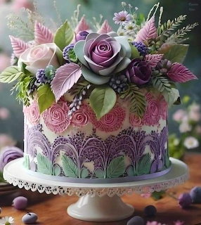 Pastel floral cake with buttercream roses and decorative piping on a white stand