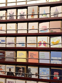 Shelves filled with postcards and souvenir cards organized in rows and compartments