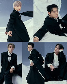 Five young men in black suits and coats posing in a winter-themed studio photo shoot