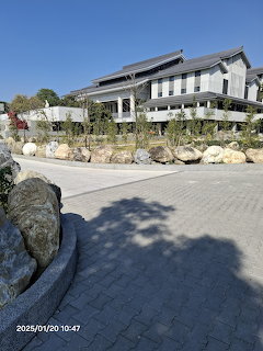 Modern building with rock garden landscaping and brick paved walkway in Tainan Zhuxi park area