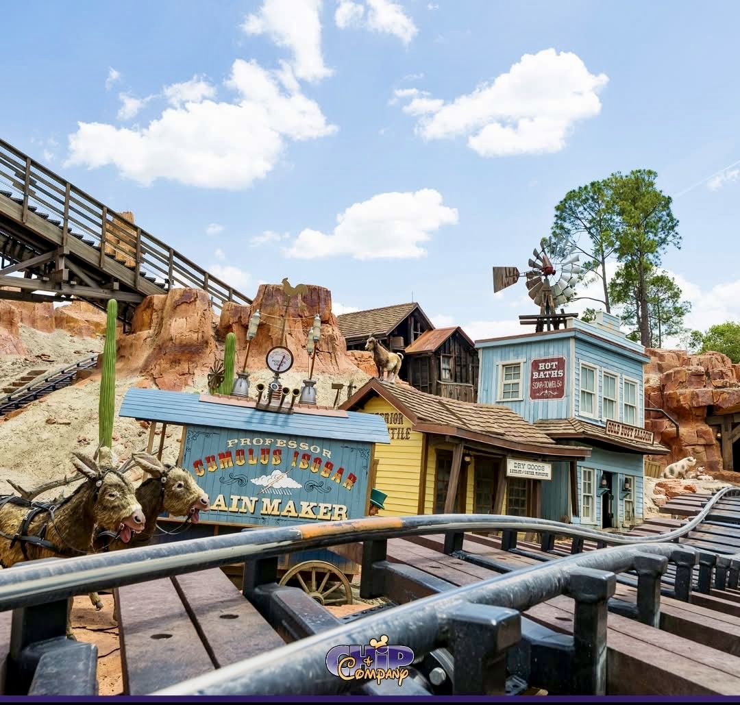 Big Thunder Mountain Railroad station at a theme park with Western desert theming and roller coaster tracks