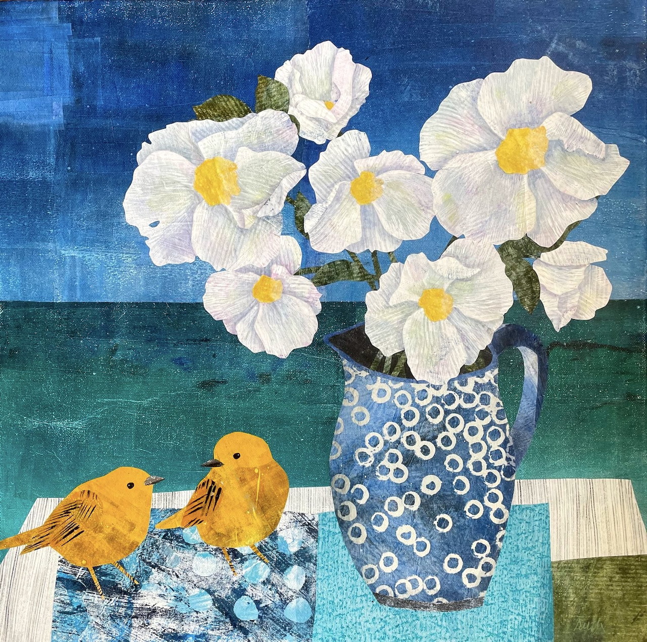 White flowers in blue patterned pitcher with two yellow birds on decorative surface