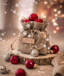 Burlap sack of Christmas ornaments on a wood slice with red baubles and snowflake overlay