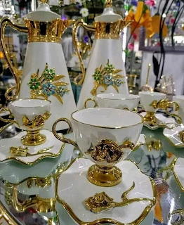Elegant porcelain tea set with gold trim and floral pattern