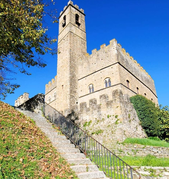 Medieval Castello di Poppi fortress with tower and battlements under a clear blue sky, Arezzo, Tuscany