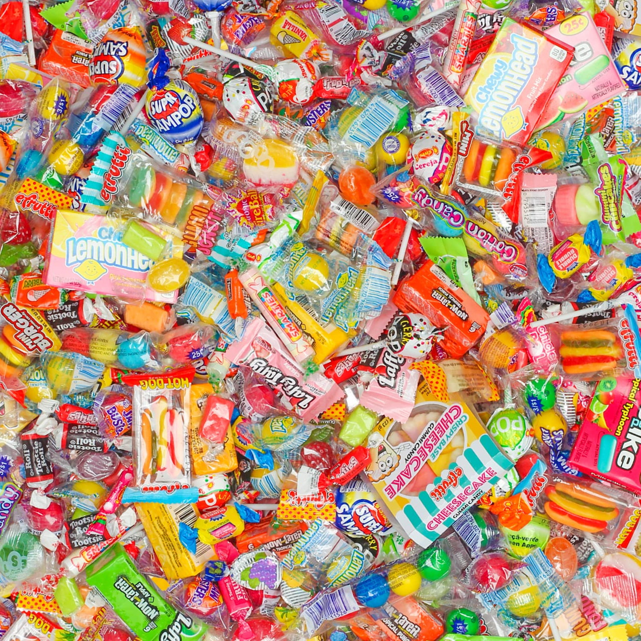 Overhead view of many colorful wrapped candies and sweets covering the entire image