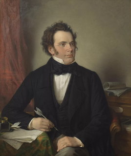 Oil portrait of Franz Schubert seated at a desk with papers and a quill