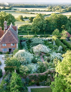 Aerial view of formal white garden with geometric hedges and castle tower at Sissingurst Castle Garden