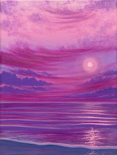 Pink and purple sunset over a calm ocean with glowing reflections on the water