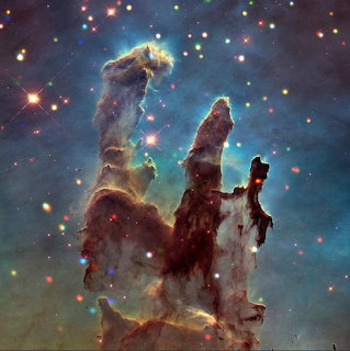 Pillars of Creation nebula with towering gas columns, stars, and colorful cosmic clouds in deep space