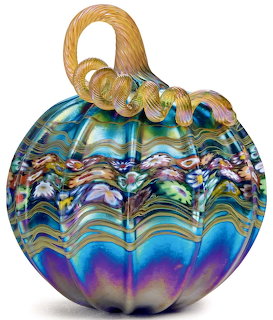 Colorful iridescent glass pumpkin with wavy multicolor patterns and curved stem