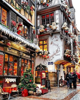 European village street with half-timbered buildings decorated with Christmas ornaments and tedy bears